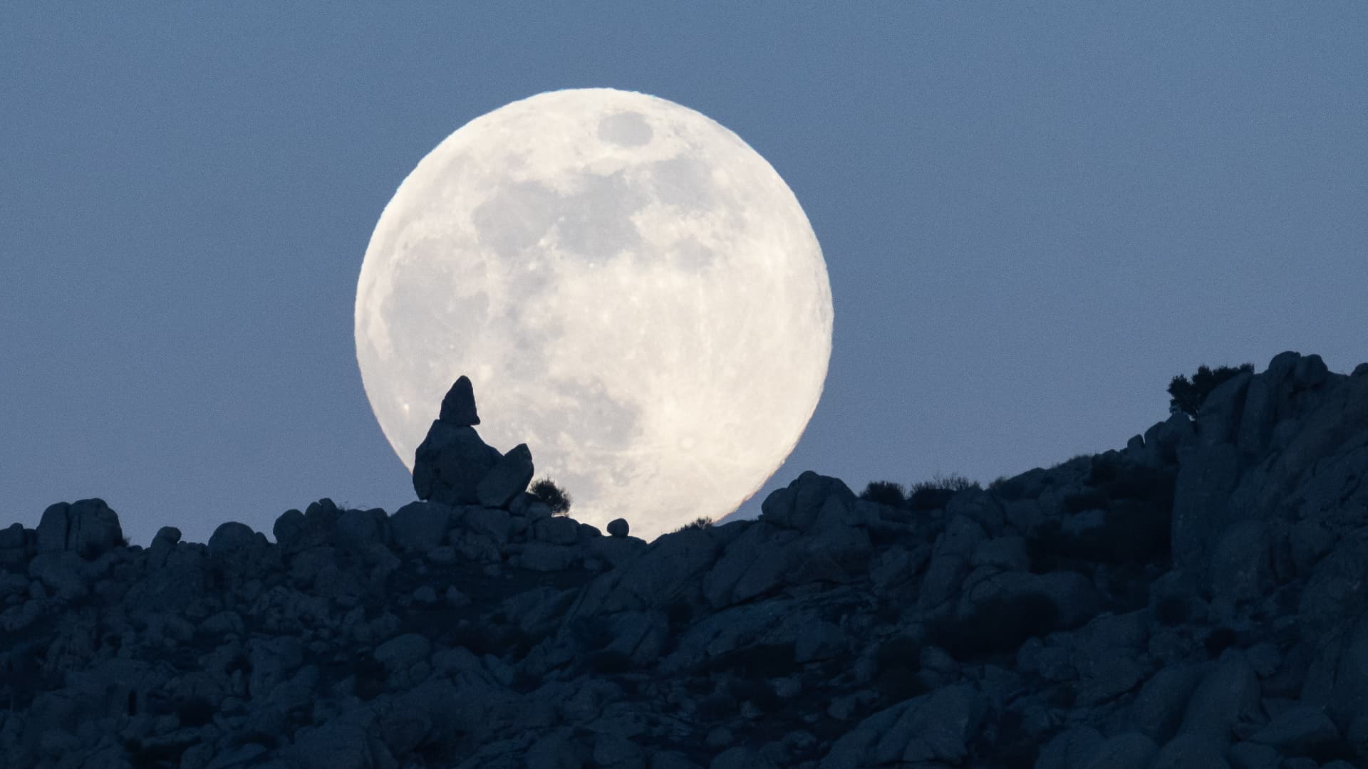 A Wolf Moon creeps over the rock formations of Sierra de Guadarrama in January 2025.  (Image credit: Marcos del Mazo/LightRocket via Getty Image)
