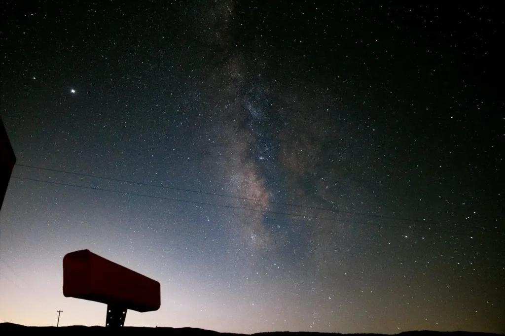 Milky Way visible above a light-polluted horizon at night