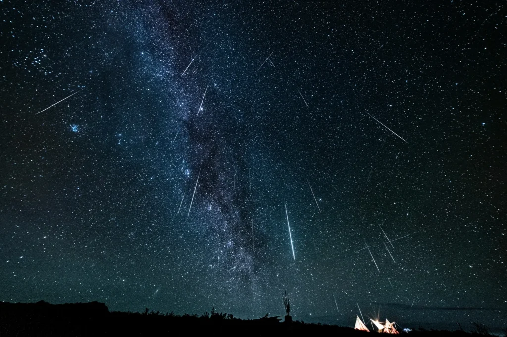 Draconid meteor shower streaking across a dark star-filled sky above the Milky Way